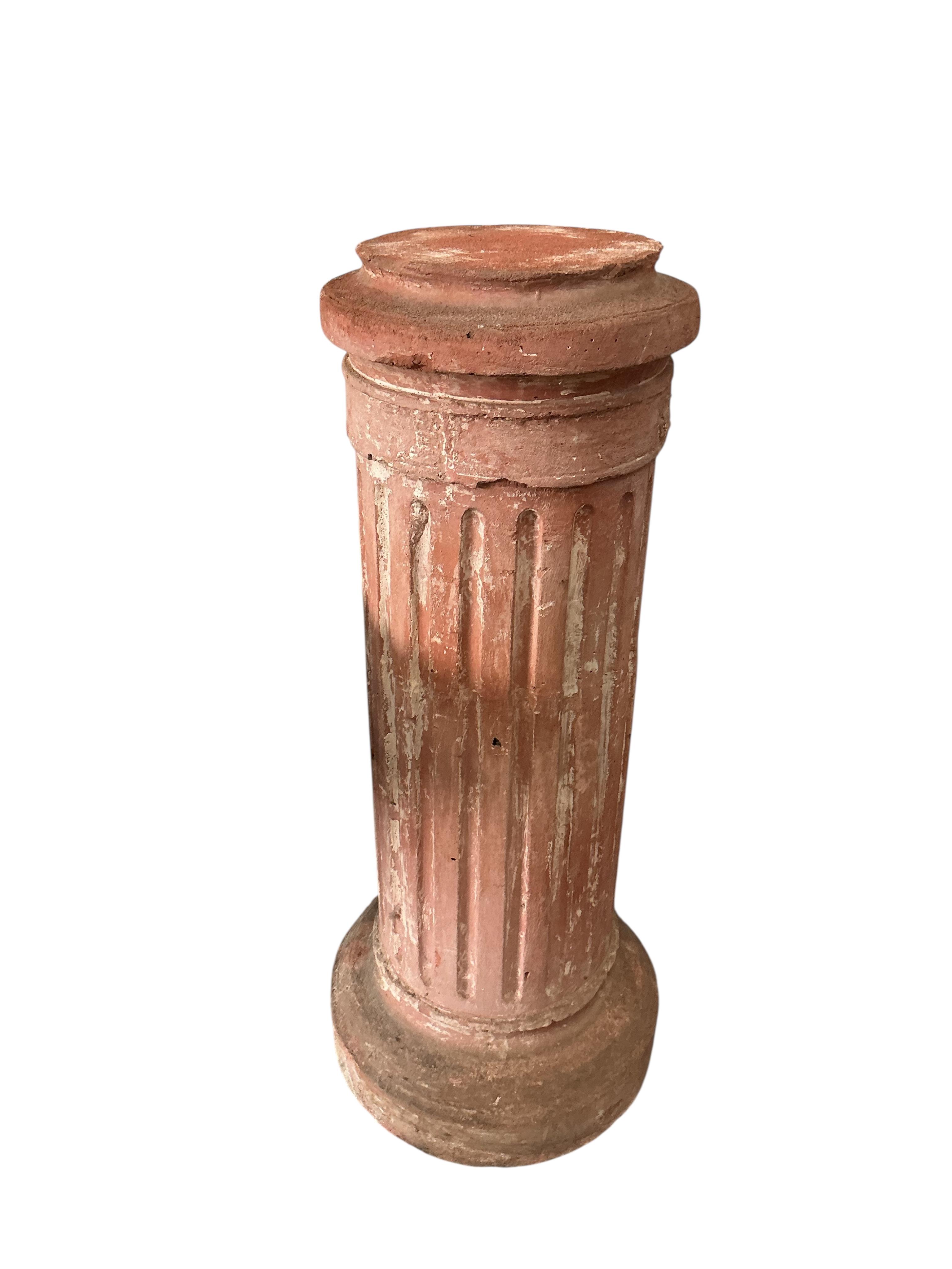 A pair of Neoclassical Revival terracotta busts on fluted pedestals, larger height 188cm, Provenance: The late Kenneth Turner (1936-2025), celebrity florist, designer and perfume retailer, he received the Royal Warrant f